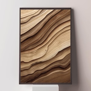 Peut inclure: Impression d'art encadrée avec un motif abstrait en nuances de marron et beige. L'œuvre d'art ressemble à du bois en couches, avec des lignes courbes créant de la profondeur. Le cadre marron foncé complète les tons naturels de l'impression.