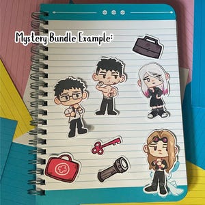 May include: A spiral-bound notebook with a teal cover and lined paper. Several cartoon stickers are placed on the notebook, including characters and objects like a briefcase, key, and first aid kit. The text "Mystery Bundle Example:" is written on the top left.