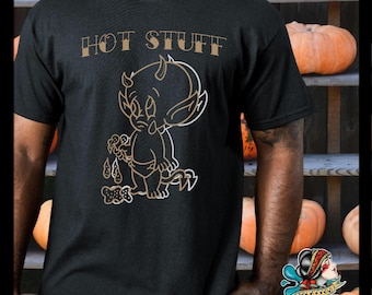 May include: Black t-shirt with a gold outline of a cartoon devil holding a lollipop and the text "HOT STUFF" printed on the front.