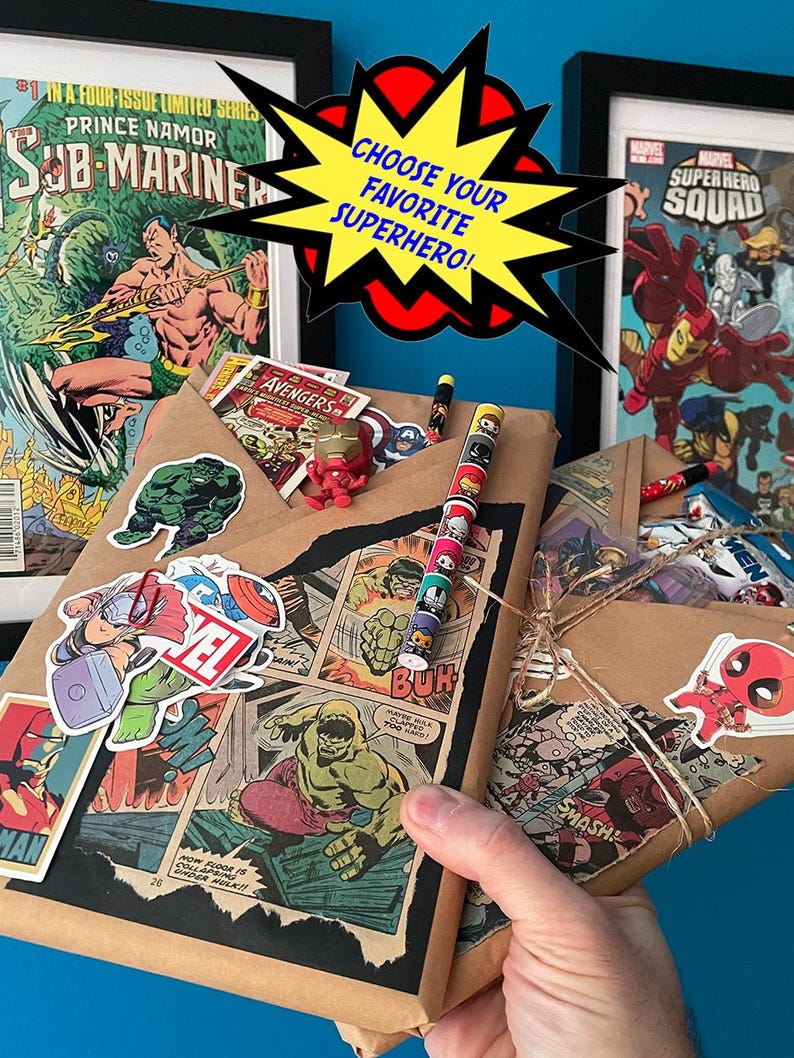 May include: A brown paper gift bag wrapped with comic book pages featuring superheroes like Hulk and Sub-Mariner. The bag is decorated with stickers of various superheroes, including Deadpool, Thor, and Captain America. The bag is tied with twine and has a tag that says "Choose your favorite superhero!"