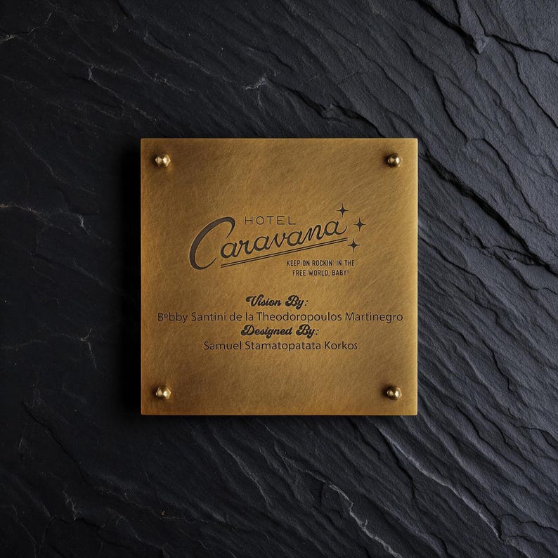 May include: A square brass plaque with four corner studs featuring the engraved text Hotel Caravana, Keep on Rockin in the Free World, Baby, Vision By: Bobby Santini de la Theodoropoulos Martinegro, and Designed By: Samuel Stamatopatata Korkos.