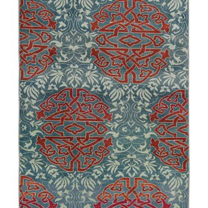 May include: A blue rug with a repeating pattern of red and orange stylized floral designs.