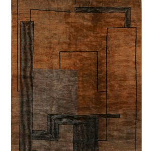 May include: A brown and black geometric rug with a modern design. The rug has a fringe border and is made of wool.