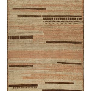 May include: A beige and brown area rug with a geometric pattern. The rug has a fringe border.