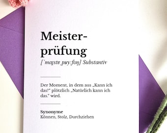May include: A white card with the German word "Meisterprüfung" printed in black, along with a definition and synonyms. The card is set against a purple envelope and decorated with pink crochet flowers.