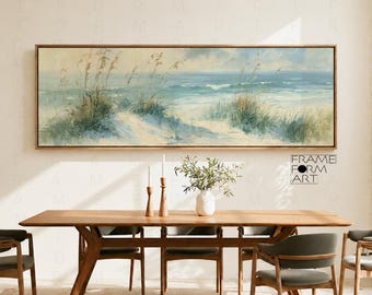 May include: A panoramic landscape painting in a wooden frame depicting a coastal scene with sand dunes, tall beach grass, and a blue ocean under a soft sky. The artwork is displayed above a wooden dining table with chairs and a vase.