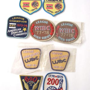 May include: A collection of nine vintage bowling patches. The patches are in various colors and feature different designs, including the text "WIBC", "League Champion", "High Series", "600 Club", and "200".