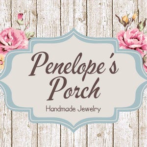 May include: A light blue sign with a white background and the text "Penelope's Porch Handmade Jewelry" surrounded by pink and yellow flowers on a woodgrain background.