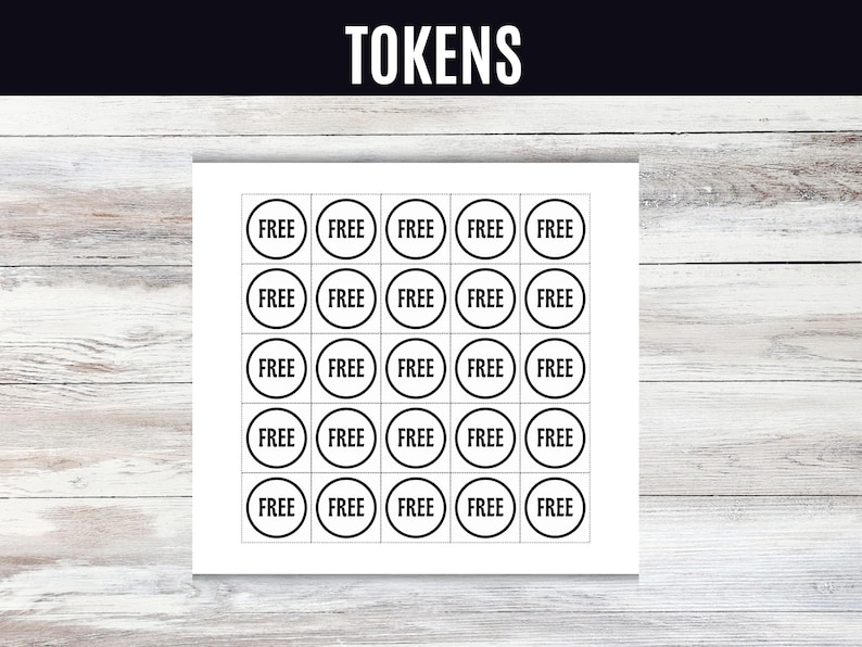 May include: A white sheet with a grid of black-bordered circles, each labeled "FREE" in a bold font. The word "TOKENS" is at the top in a bold font. The background is a light wood grain.