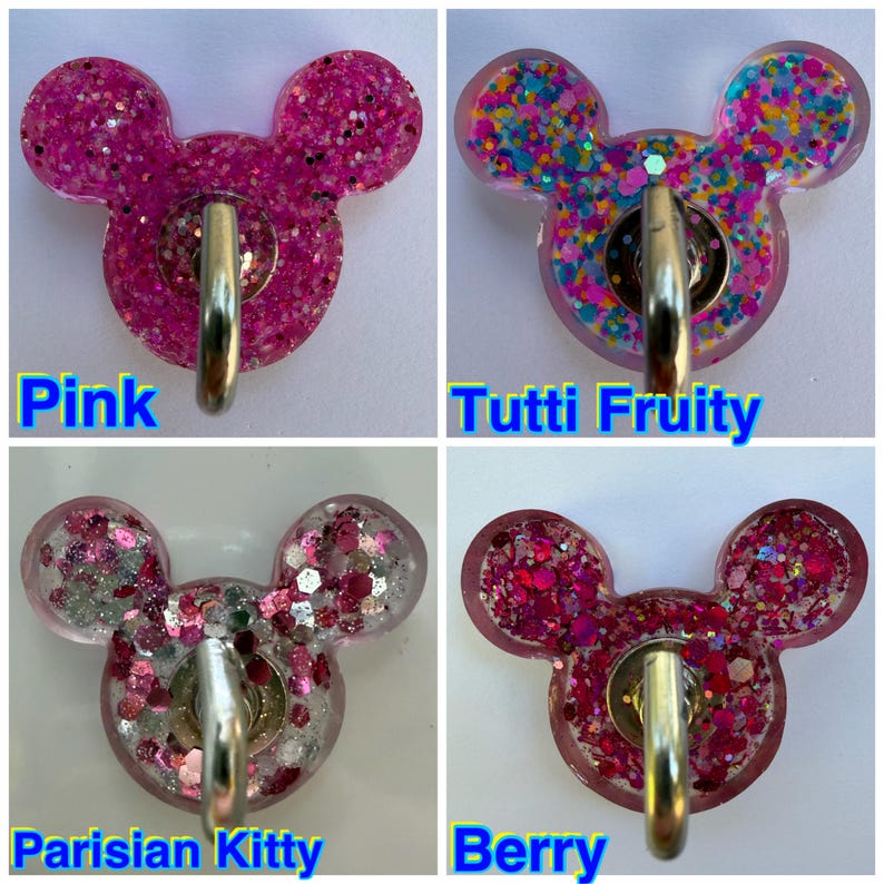 May include: Four mouse-shaped wall hooks with metallic silver hardware. The top left is pink glitter, top right is multi-colored confetti, bottom left is pink and silver glitter, and bottom right is dark pink and red chunky glitter.
