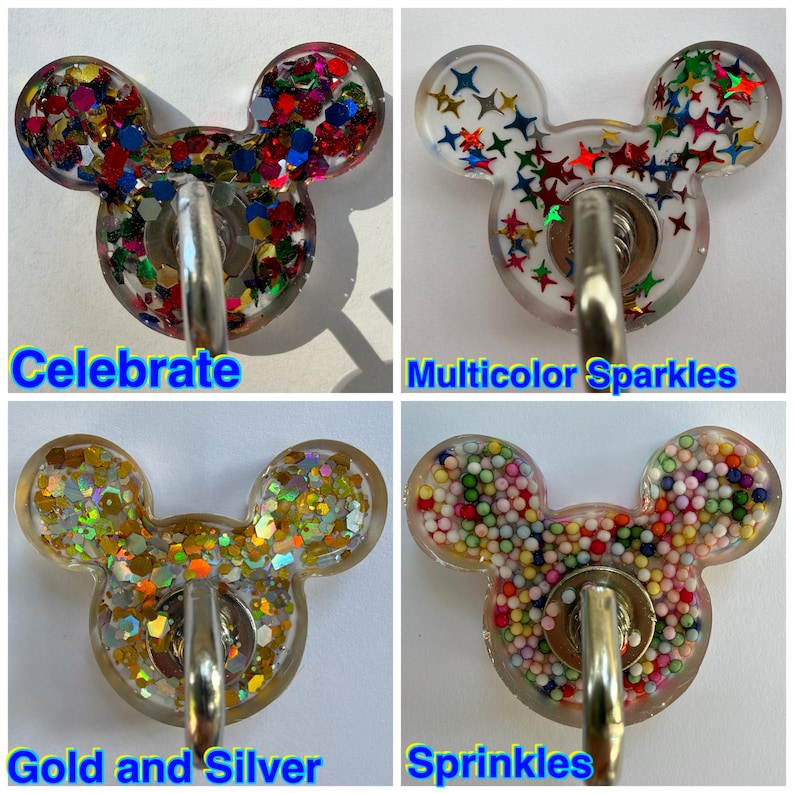 May include: Four resin wall hooks shaped like mouse heads. Top left: Celebrate with multicolored hexagonal glitter. Top right: Multicolor Sparkles with star-shaped glitter. Bottom left: Gold and Silver with metallic flakes. Bottom right: Sprinkles with small colorful spheres.