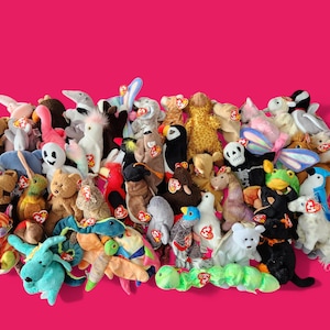 May include: A large collection of colourful plush toys, mostly animals, with a few abstract shapes. The toys are arranged in a pile, with some of them overlapping. The toys are all different sizes and shapes, and they are all made of soft, cuddly material.
