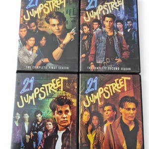 May include: Four DVD cases for the television series "21 Jump Street". Each case features a different cast photo and the show's logo in neon blue. The seasons are labelled "The Complete First Season", "The Complete Second Season", "The Complete Third Season", and "The Complete Fourth Season".