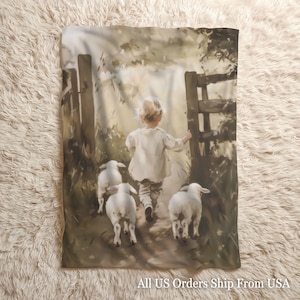 May include: A blanket featuring a pastoral scene of a child leading three lambs through a wooden gate. The artwork is rendered in muted tones of beige, brown, and white, creating a vintage aesthetic. The blanket has a soft, inviting appearance.