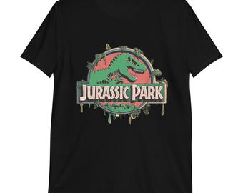 May include: Black t-shirt featuring the "Jurassic Park" logo. The design includes a green dinosaur skeleton inside a red circle, surrounded by palm trees. The words "JURASSIC PARK" are in a white font.