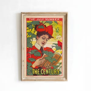 Puede incluir: Póster vintage enmarcado con una mujer vestida de rojo y sombrero leyendo un libro. El póster tiene el texto "THE JULY NUMBER" en la parte superior y "THE CENTURY" en la parte inferior, con follaje verde.