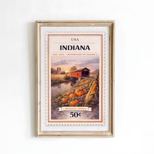 Puede incluir: Impresión enmarcada de un sello de Indiana con un puente cubierto rojo, calabazas y maíz. El sello dice "USA INDIANA" y "Midwest Series" con un valor de 50¢. La obra de arte está ambientada en un atardecer.
