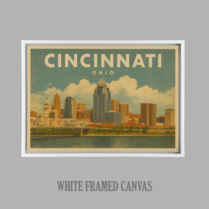 May include: A white framed canvas print displaying a vintage illustration of the Cincinnati, Ohio skyline. The artwork includes the city's name and state, with a river and bridge in the foreground. The canvas is framed in a white border.