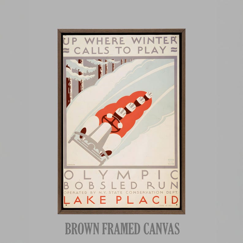 May include: A framed vintage poster advertising the Olympic Bobsled Run in Lake Placid. The artwork depicts a bobsled team in a red sled racing down a snowy track, with text that reads "Up Where Winter Calls to Play."