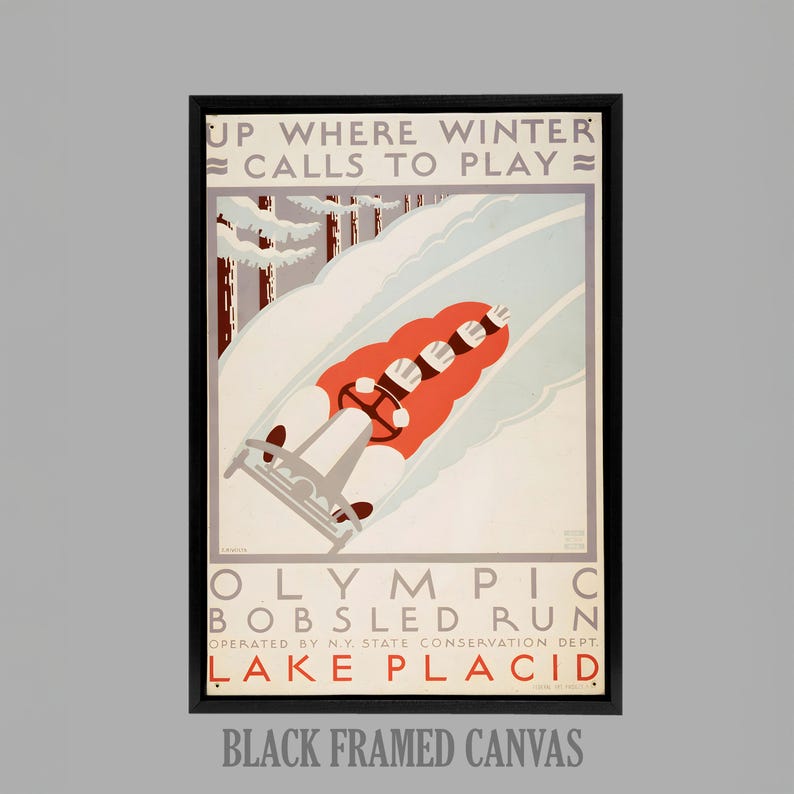 May include: Black framed canvas print of a vintage Olympic bobsledding poster. The poster features a red bobsled racing down a snowy track, with the text "UP WHERE WINTER CALLS TO PLAY" at the top and "OLYMPIC BOBSLED RUN LAKE PLACID" at the bottom.