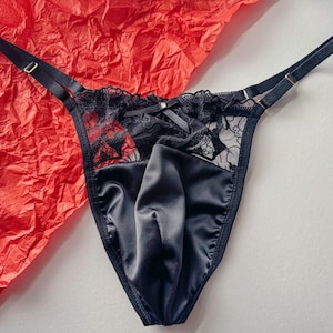 May include: Black lace and satin lingerie with adjustable straps.