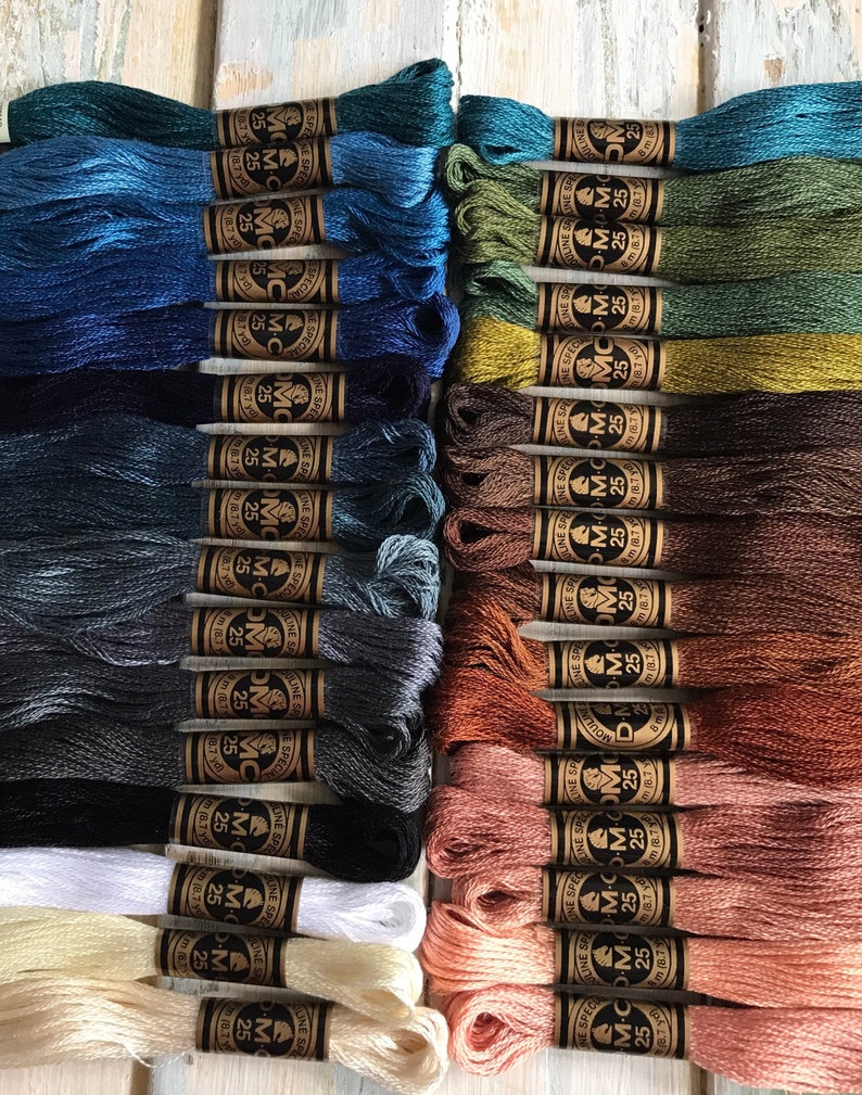 May include: A collection of 40 spools of DMC embroidery floss in various shades of blue, green, brown, beige, and white. Each spool is labeled with the DMC color number and the text "DMC - Moulin&eacute; Special - 25m (8.7 yds)".