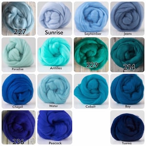 May include: A collection of 12 wool rovings in various shades of blue and green. The rovings are arranged in a grid pattern and labelled with their colour names and numbers. The colours include 227, Sunrise, September, Jeans, Paradise, Antilles, 229, 214, Chagall, Water, Cobalt, Bay, 236, Peacock, and Tuareg.