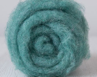 May include: A ball of teal blue wool roving, a type of fiber used for felting and spinning.