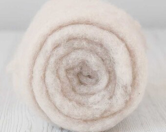 May include: A roll of natural white wool roving, a soft and fluffy fiber used for spinning yarn, felting, and other crafts.