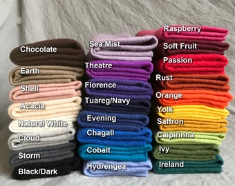 May include: A stack of 18 different colored felt squares with the names of each color written on the front of each square. The colors include Raspberry, Sea Mist, Soft Fruit, Chocolate, Passion, Theatre, Earth, Rust, Florence, Shell, Orange, Tuareg/Navy, Acacia, Yolk, Evening, Natural White, Saffron, Caipirinha, Cobalt, Ivy, Storm, Hydrengea, Ireland, and Black/Dark.