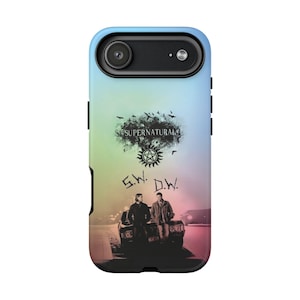 May include: A phone case with a gradient background of blue, green, and pink. The case features the text "SUPERNATURAL" above a symbol and the initials "S.W. D.W." with two figures and a car. The case is black around the edges.