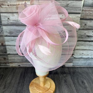 May include: A white ceramic mug with a black handle and the text "But First, Coffee" in a black, bold font. The mug is on a white surface. The mug is approximately 10 cm tall.