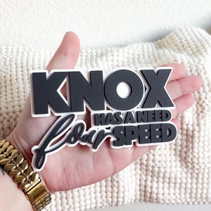 May include: Black and white vinyl sticker set with the text "Knox has a need for speed".