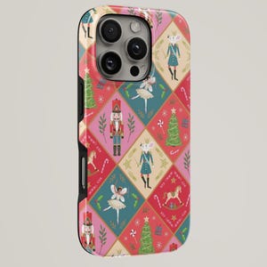 May include: A phone case featuring a repeating diamond pattern in shades of pink, red, and teal. The design includes illustrations of nutcrackers, mice in crowns, ballerinas, Christmas trees, rocking horses, and candy canes on a festive background.