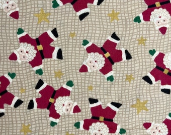 May include: Beige fabric with a repeating pattern of red and white Santa Claus figures in a star shape. The background has a grid pattern and gold stars.