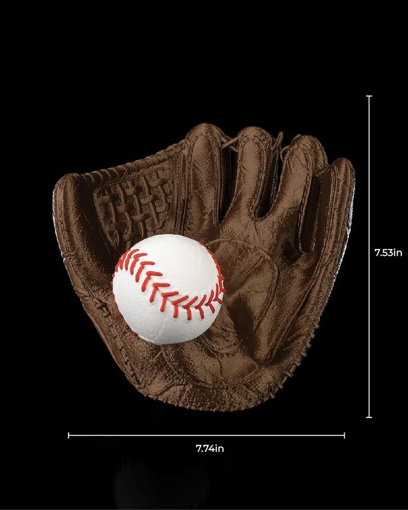 May include: A brown leather baseball glove with a white baseball inside. The baseball has red stitching. The glove is 7.74 inches wide and 7.53 inches tall. The background is black.