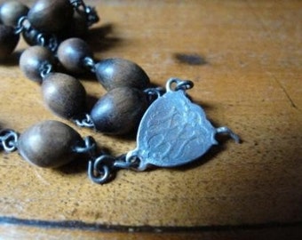 A piece of vintage wooden rosary crow