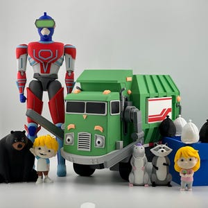 May include: A collection of plastic figures including a tall blue, red, and white robot, a green garbage truck, a black bear, a raccoon, a rat, two small children with blonde hair, and several small white and black trash bags.