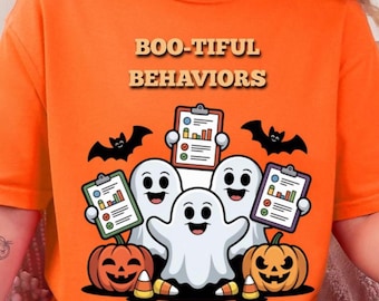May include: An orange t-shirt featuring the text BOO-TIFUL BEHAVIORS in a bold font. The graphic displays three white ghosts, two black bats, and two orange jack-o'-lanterns. The ghosts are holding clipboards with colorful bar charts and checklists.