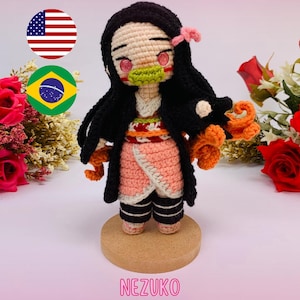 May include: A handmade crochet doll of a character with black hair, pink eyes, and a green mouth guard. The doll wears a pink kimono with a white trim and black and white striped socks. The doll is displayed on a wooden base. Text at the top reads "PDF PATTERN / PADRÃO DIGITAL".