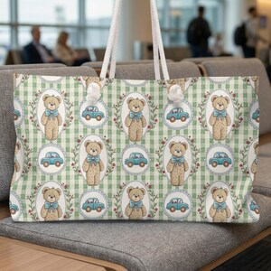 May include: A large tote bag with a repeating pattern of teddy bears wearing blue bows and light blue cars on a green and white checkered background. The bag has white rope handles.