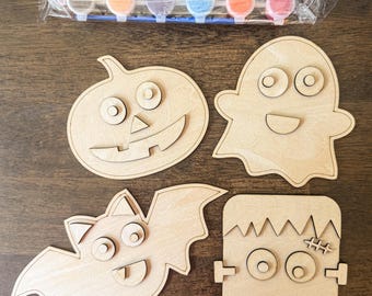 May include: A Halloween craft kit with four wooden shapes: a pumpkin, ghost, bat, and Frankenstein's monster. Includes a set of paints and a paintbrush. Ideal for a creative activity. The paints are in various colours, perfect for decorating the wooden shapes.