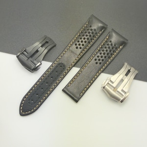 May include: Black leather watch straps with perforated detailing and contrasting yellow stitching. Includes two watch clasps, one black and one silver, for easy attachment. A stylish accessory for any watch.