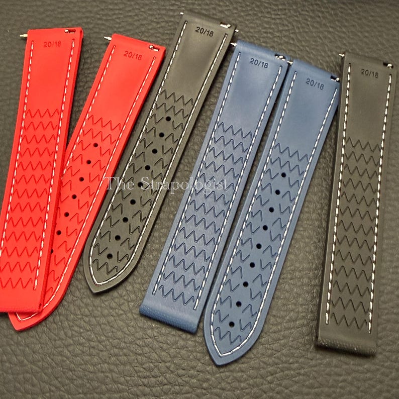 Puede incluir: Una colecci&oacute;n de correas de reloj en varios colores, incluyendo rojo, gris y azul. Cada correa presenta un patr&oacute;n en zigzag y costuras blancas. Las correas est&aacute;n etiquetadas como "20/18" y est&aacute;n hechas de un material flexible.