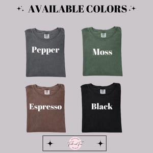 May include: Image showcasing four t-shirts in different colors: pepper, moss, espresso, and black. The text "AVAILABLE COLORS" is at the top. Each shirt has a label with its color name in white. The shirts are displayed on a light gray background.