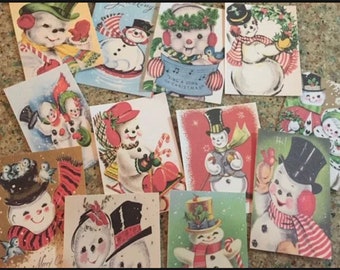 May include: A collection of vintage-style Christmas greeting cards featuring various illustrations of snowmen wearing top hats, scarves, and earmuffs, with some cards displaying festive text like Sing a Song of Christmas and Hi.