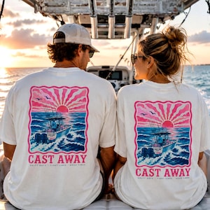 May include: Off-white short-sleeve t-shirts featuring a graphic on the back of a boat on the ocean at sunset with pink sun rays. The text reads CAST AWAY, SALTY DAYS, TIGHT LINES, GOOD TIMES. The design includes blue water and two birds.