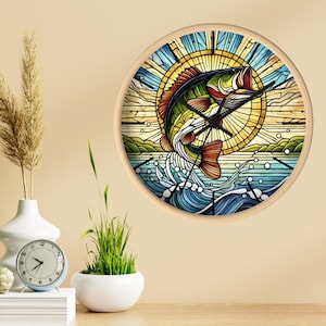 May include: A round clock with a stained glass design of a fish jumping out of the water. The fish is colorful with shades of green, red, orange, and yellow. The background is a blue and white water scene with a sun shining in the upper right corner.