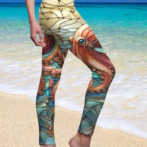 May include: High-waisted leggings with a stained-glass octopus design. The leggings feature a vibrant color palette of blues, oranges, and gold, with intricate details. The leggings are form-fitting and made of a stretchy material.