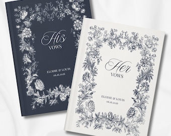 May include: Two wedding vow books, one navy blue and one white, with floral border designs. The navy book reads "His Vows" and the white book reads "Her Vows". Both books include the names "Elodie & Louis" and the date "06.16.2026".